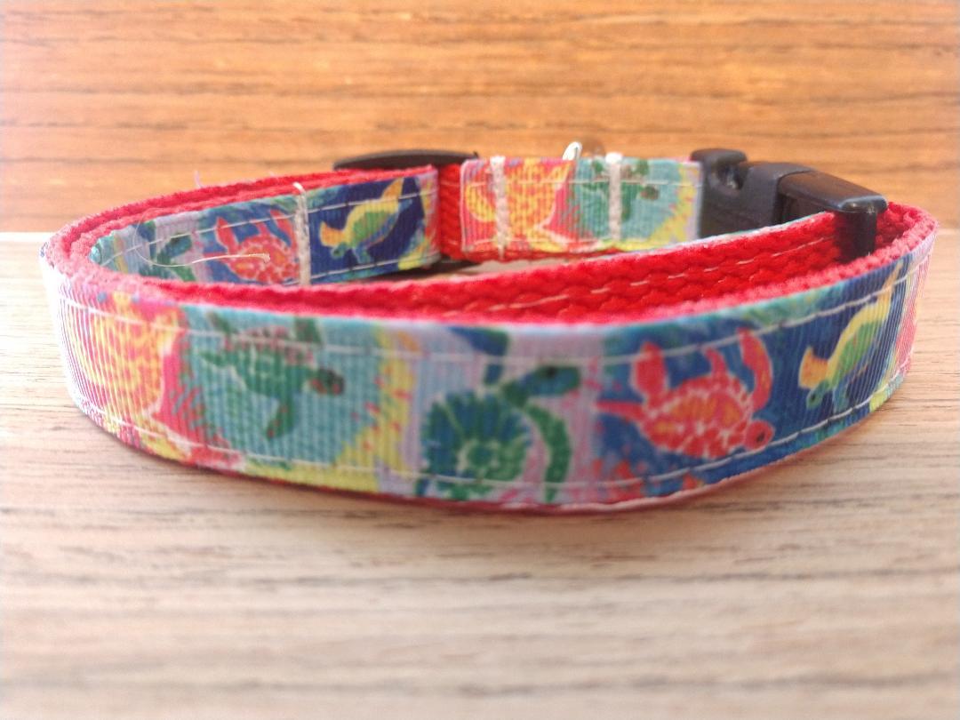 A small dog collar featuring a vibrant sea turtle design, measuring 12-16 inches in neck size, made with durable materials.